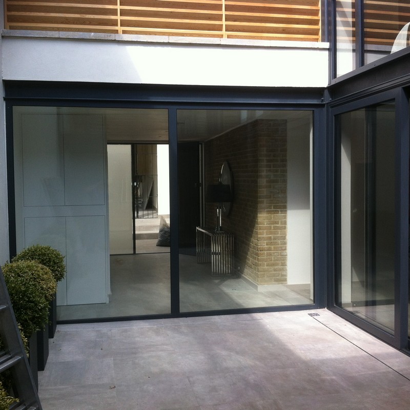 Floor-to-ceiling sliding doors opening to courtyard in Hayes